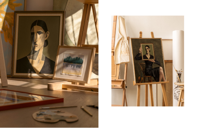 Art studio scene with framed portraits on a table and paints brushes and an easel nearby