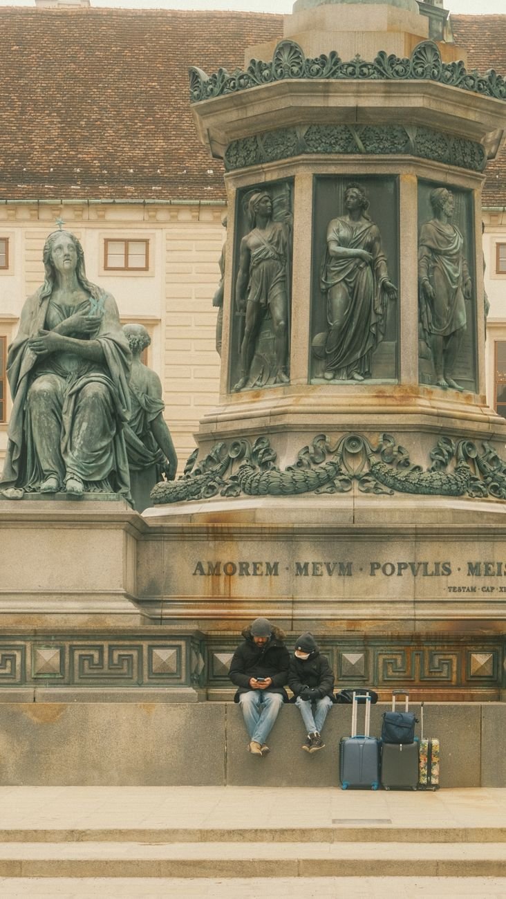 travelers resting at vienna monument