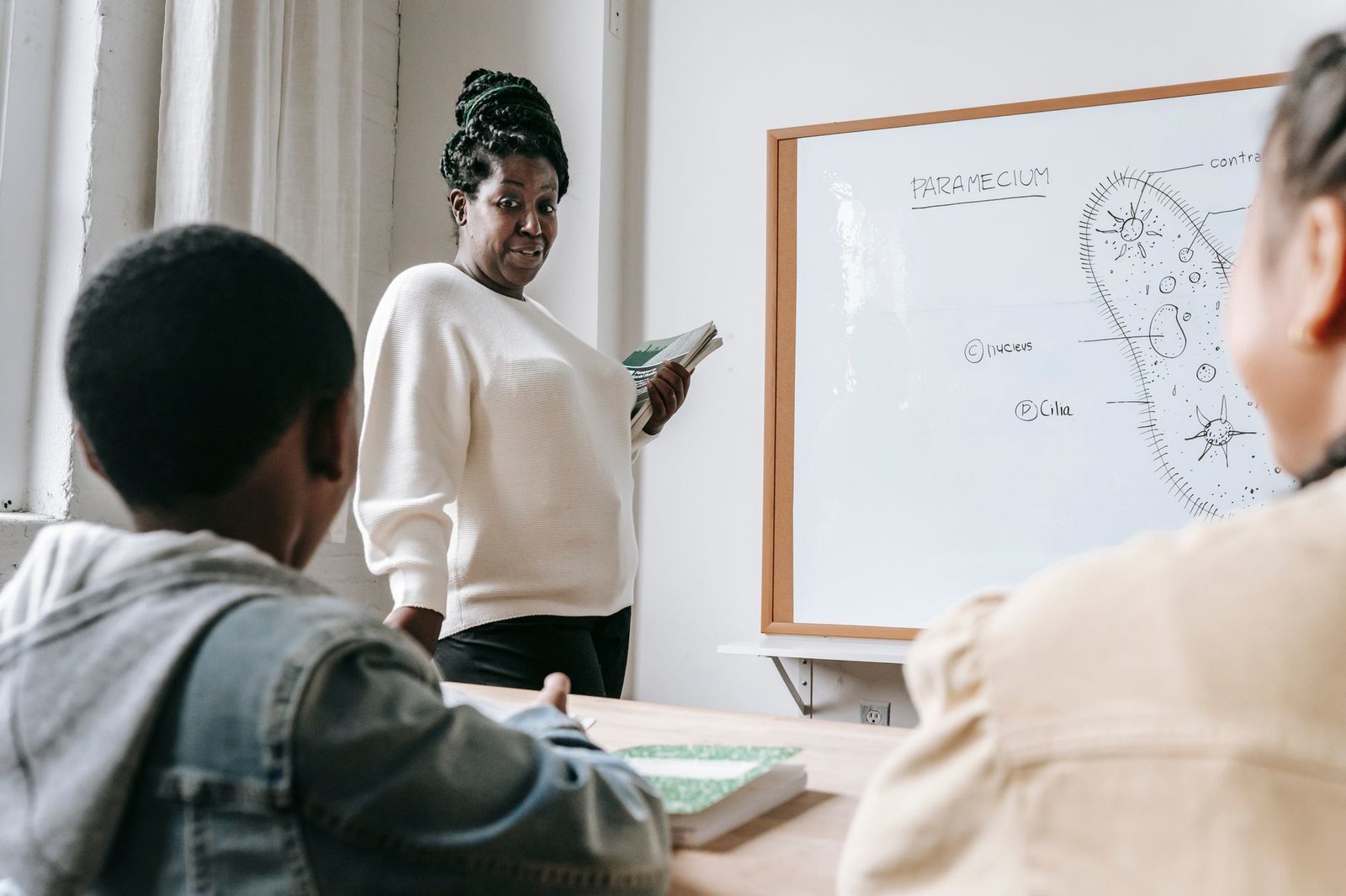 black woman with students on lesson